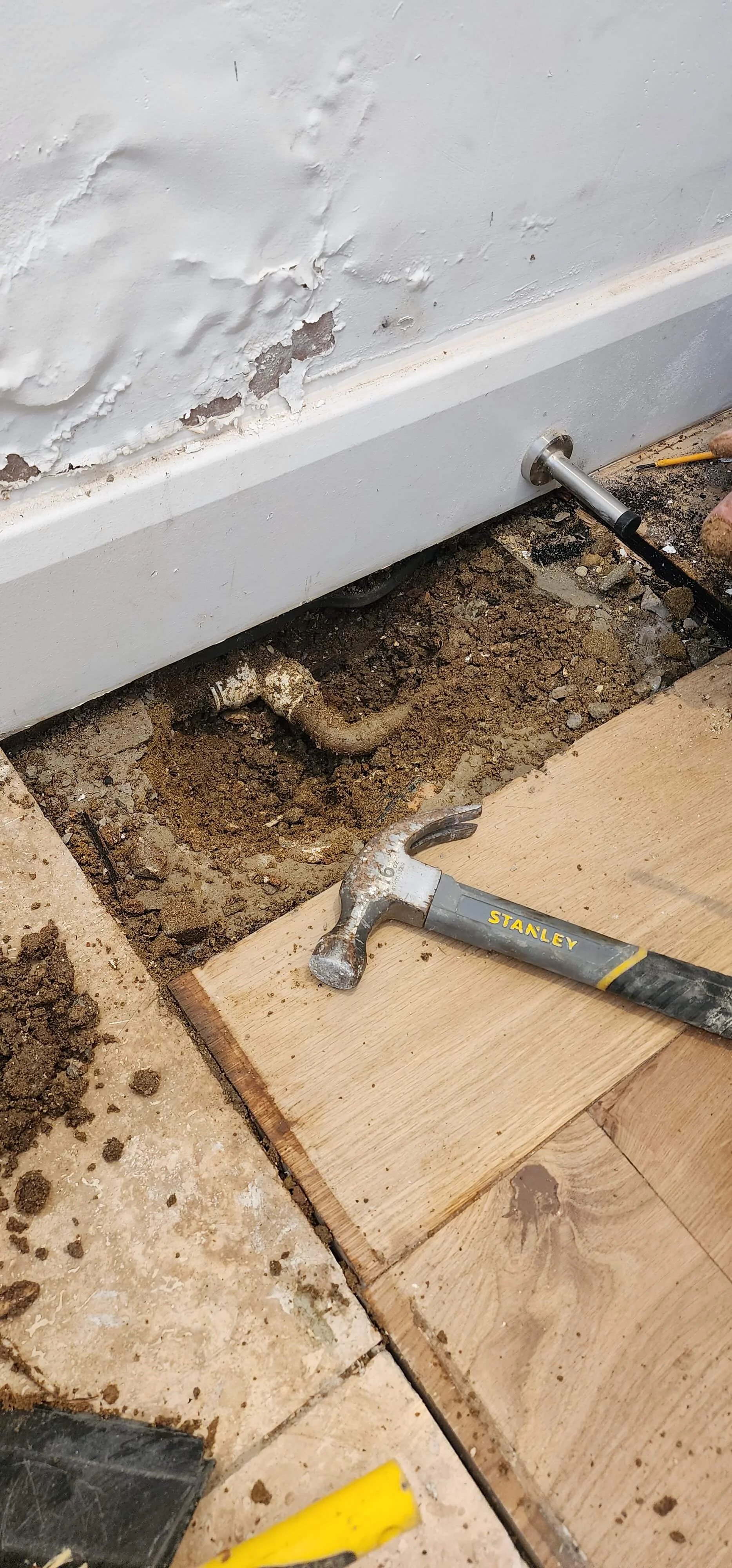 Pipework exposed beneath flooring during mains water leak detection in Ascot