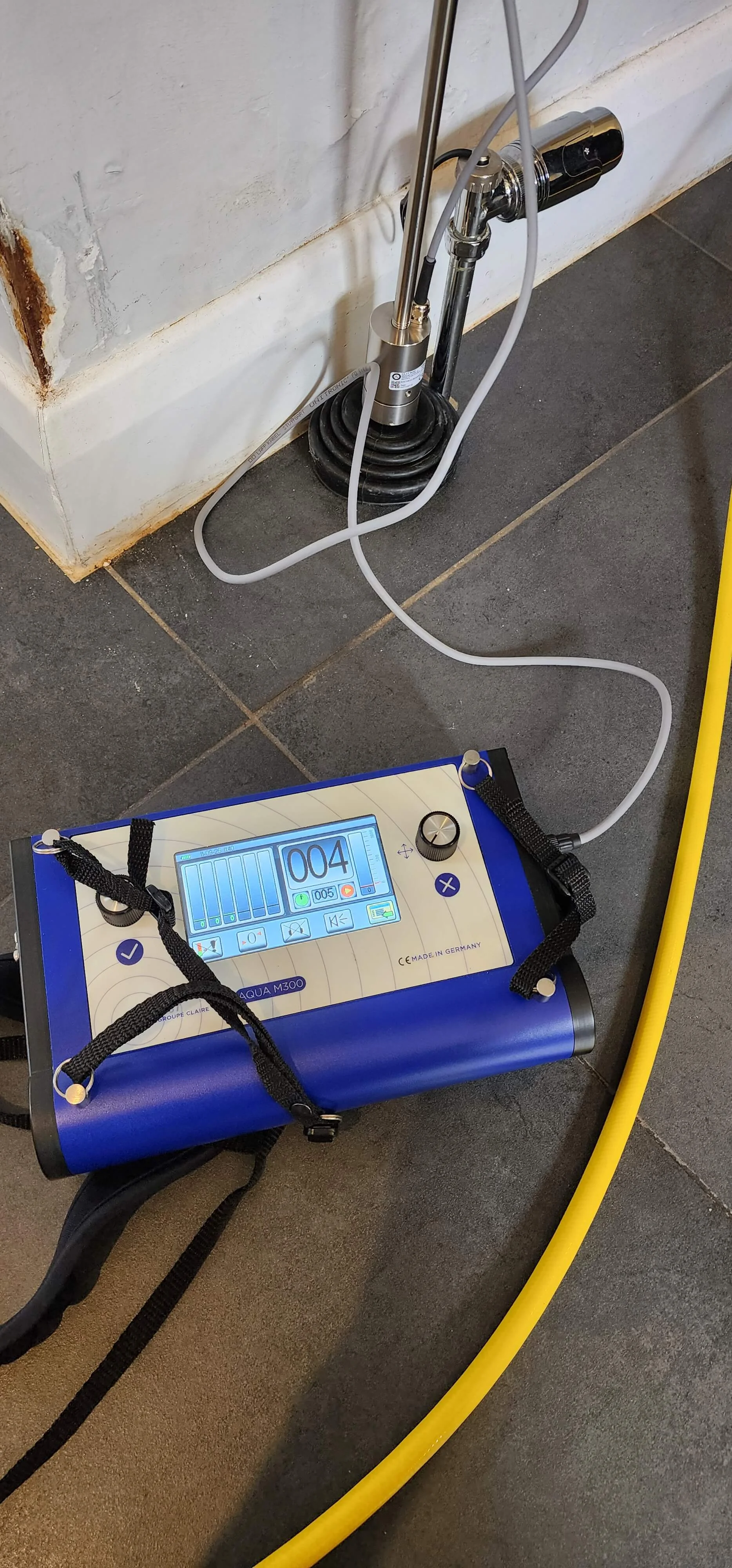 Tracer gas equipment connected during central heating leak detection in Betchworth