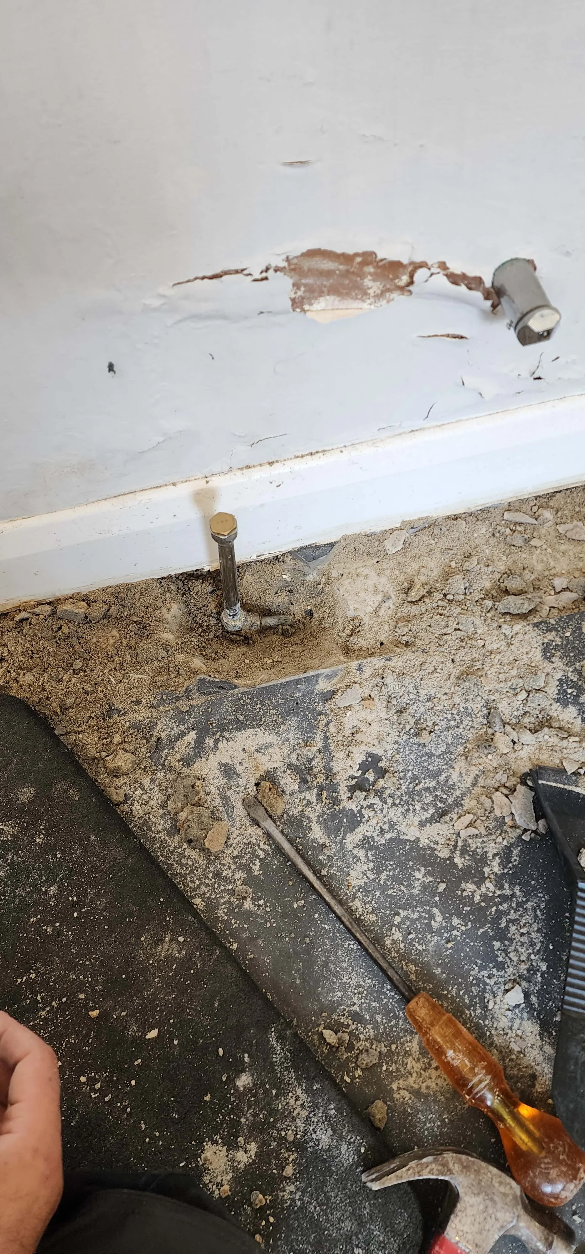 Floor opened around central heating pipework in Betchworth