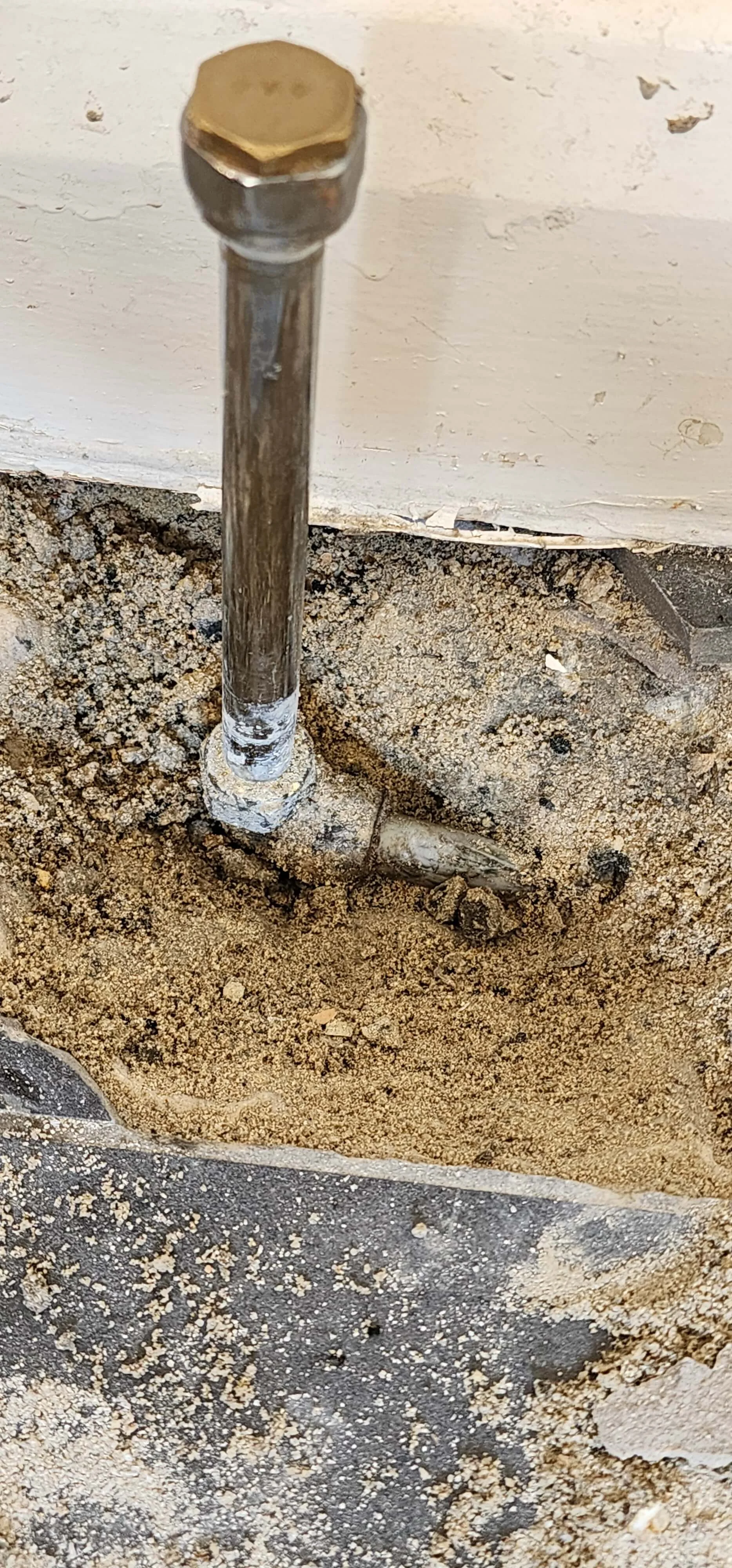 Close-up exposed radiator pipework during Betchworth leak detection