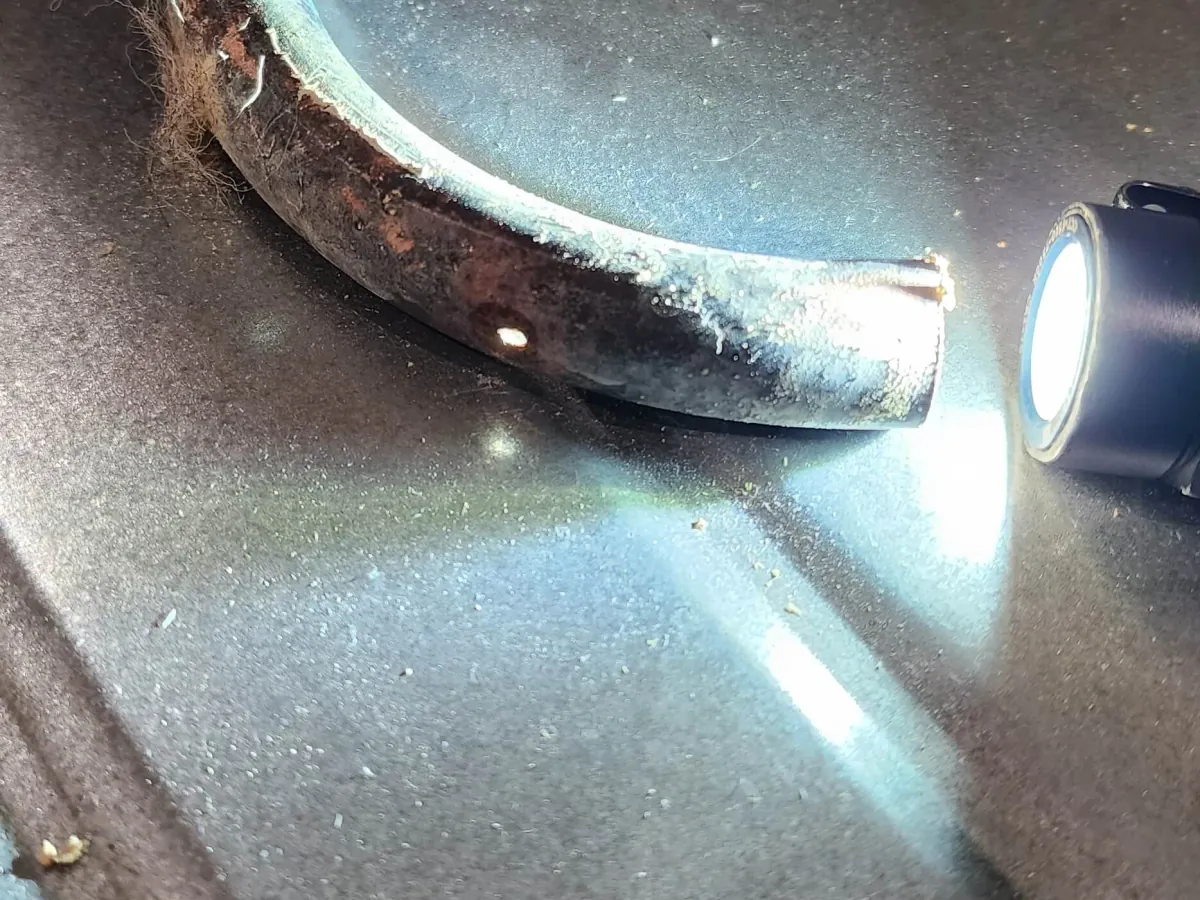 Hot water pipework evidence under inspection light in Camberley