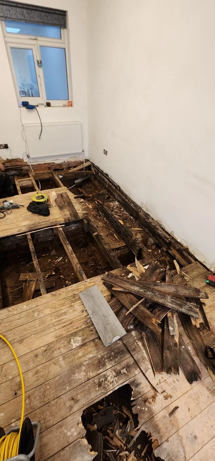 Damaged floorboards during Coventry mains water leak investigation
