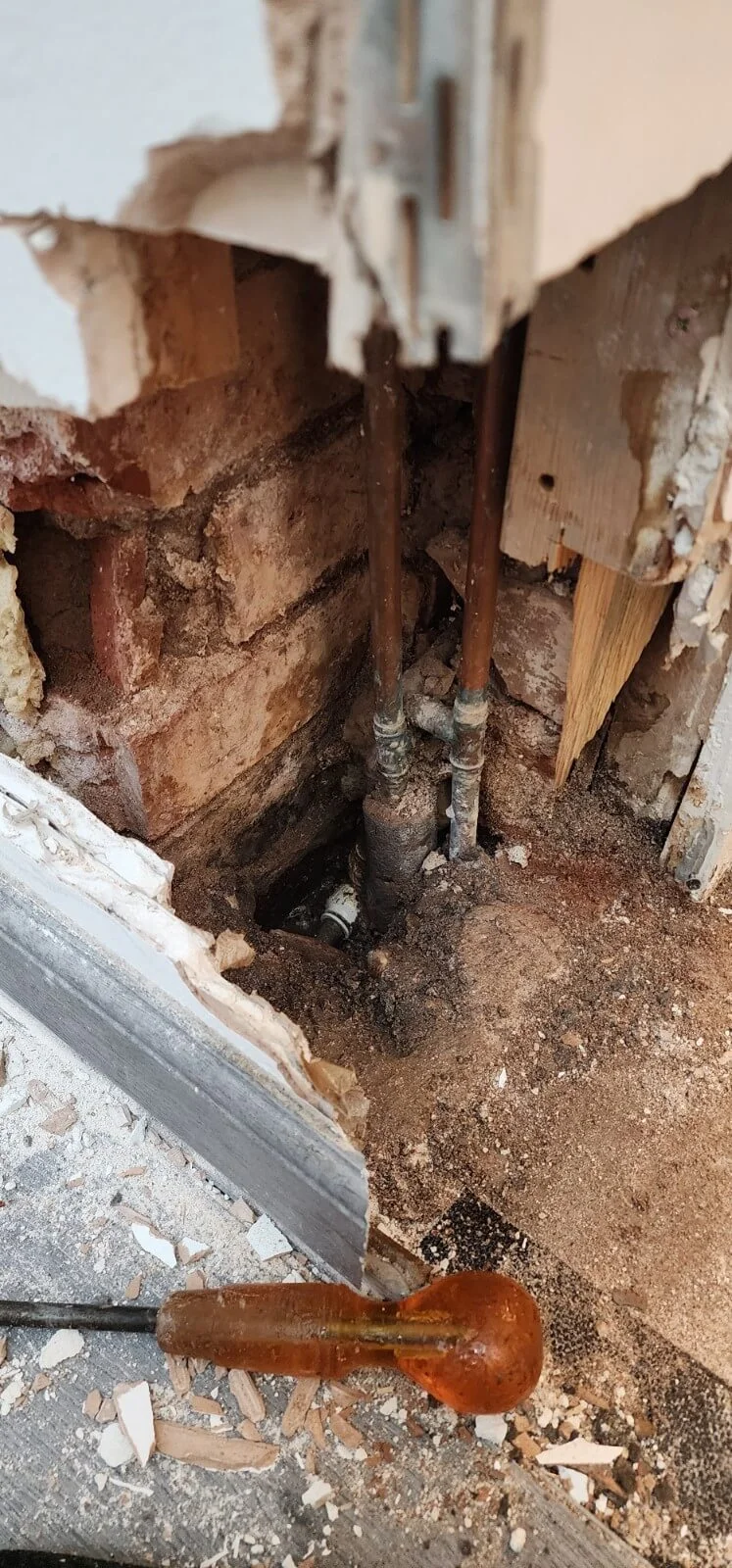 Exposed mains water pipework during Coventry leak investigation