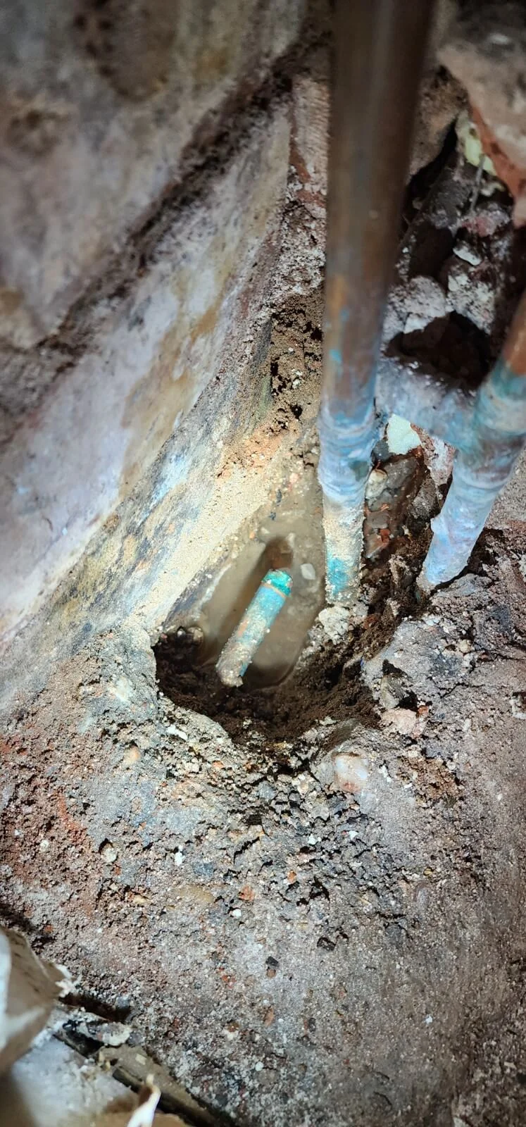 Water around exposed pipework during Coventry leak investigation