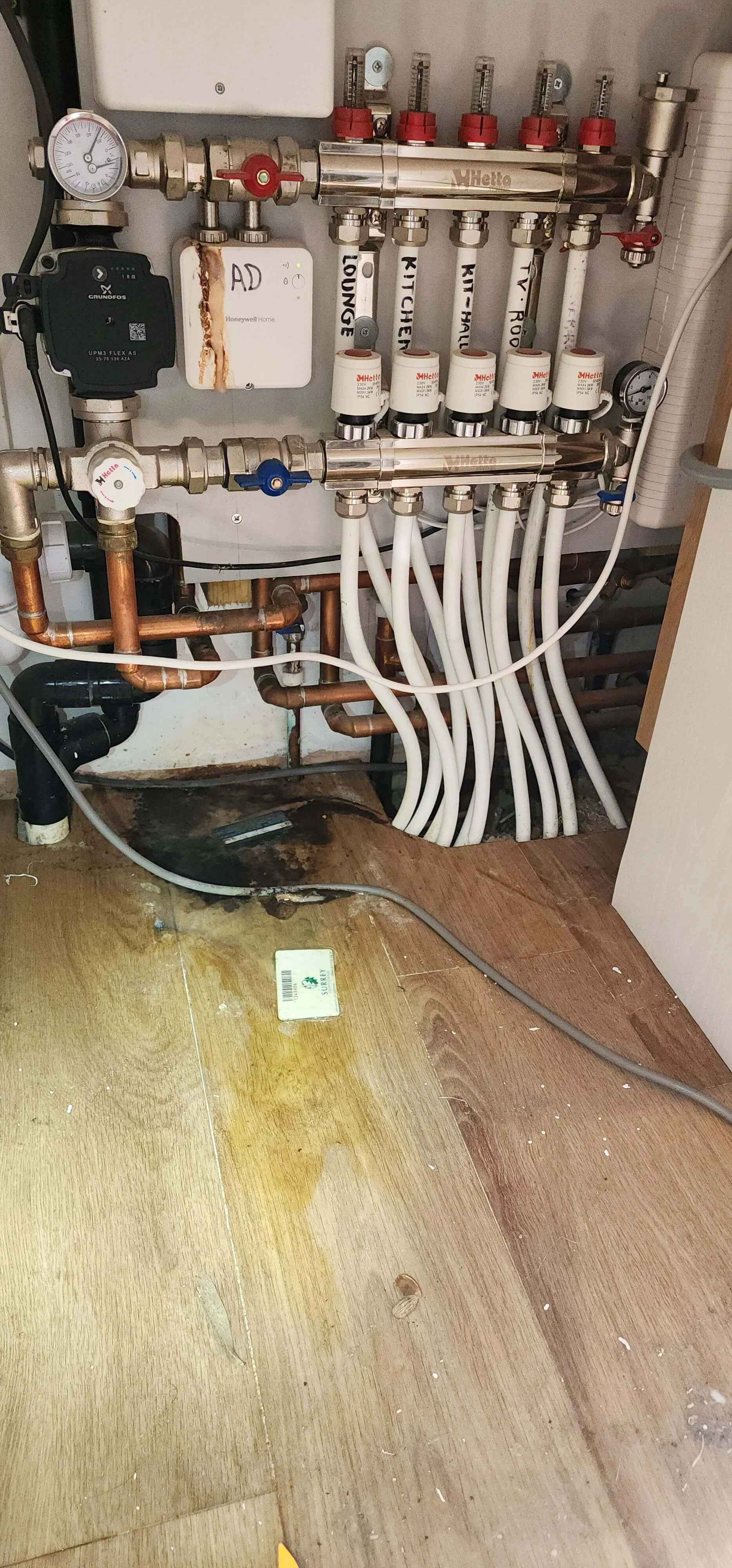 Heating manifold checked during central heating leak detection in Farnham