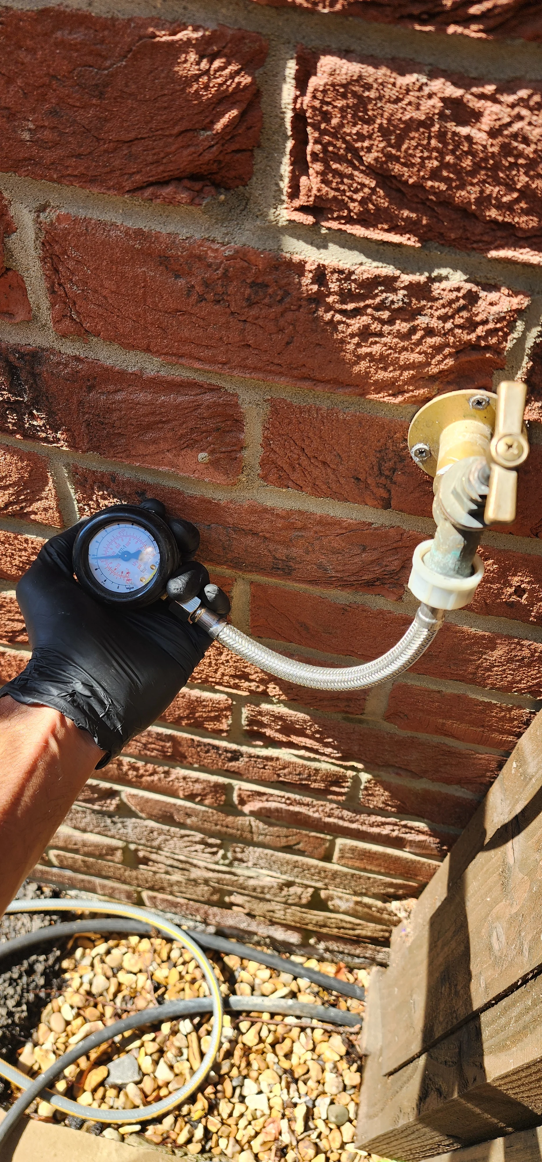 Pressure gauge connected to an external tap during water system testing