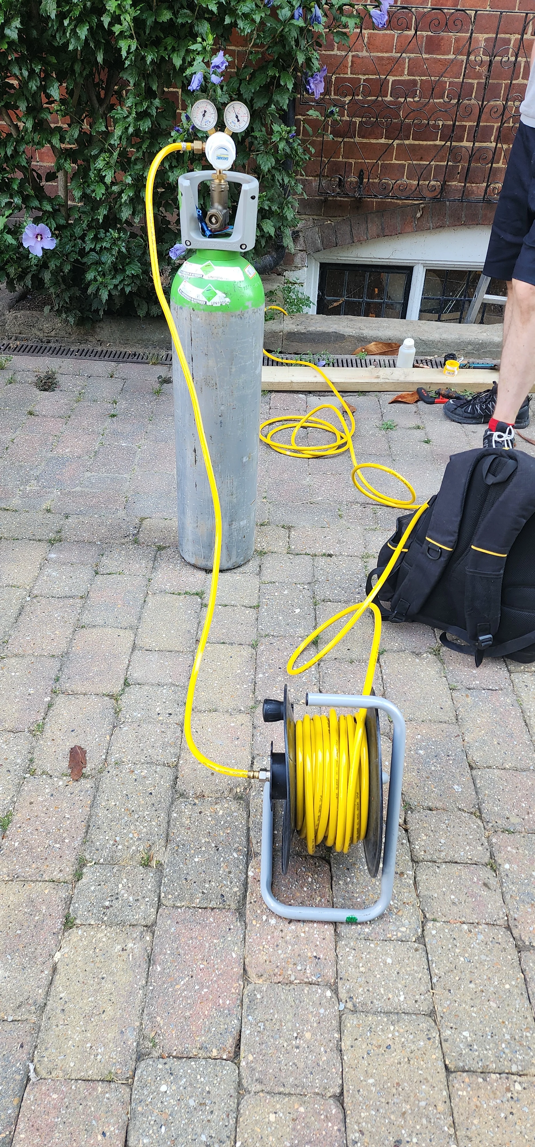 Tracer gas cylinder and hose used during mains water leak detection in Guildford