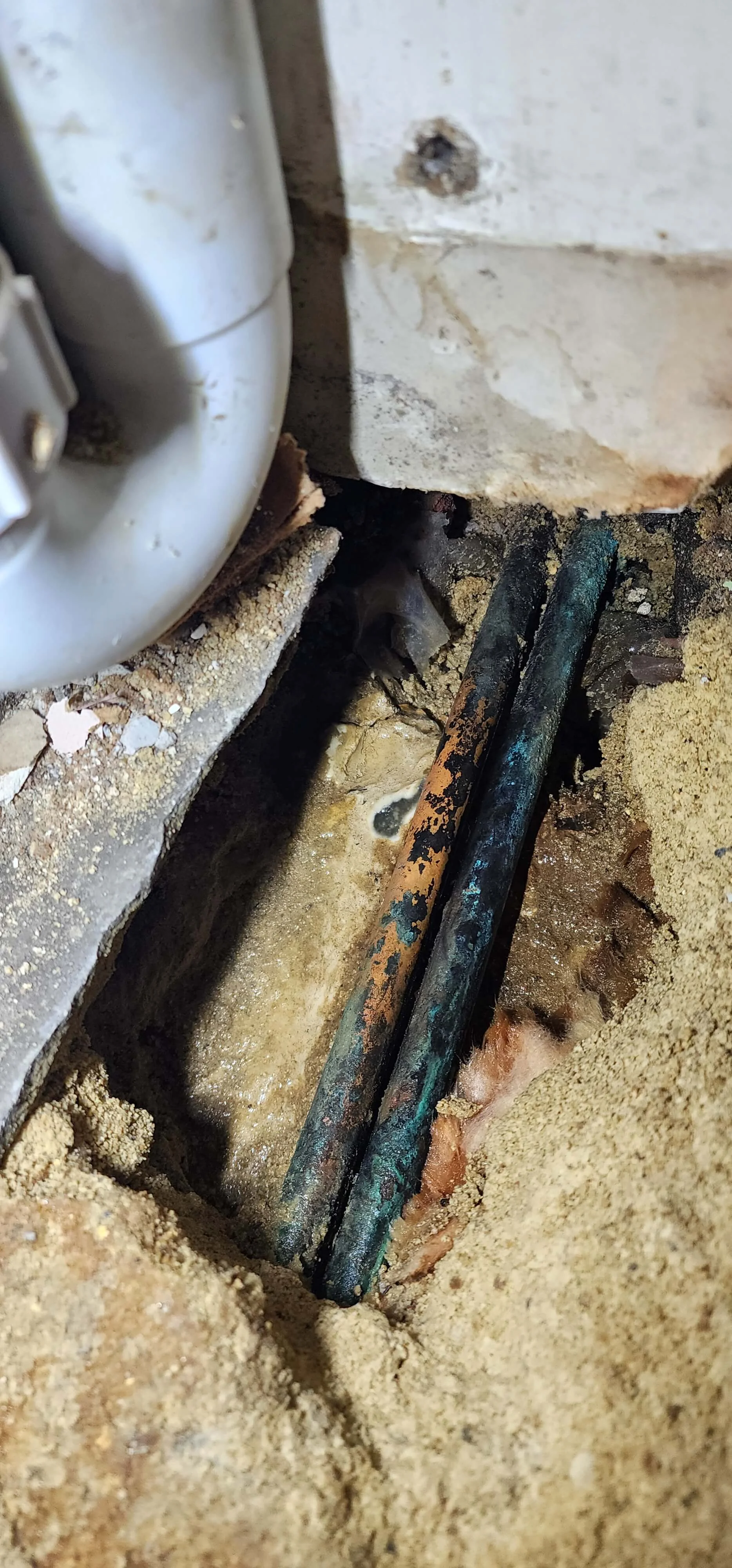Copper heating pipework exposed below floor during Reading investigation