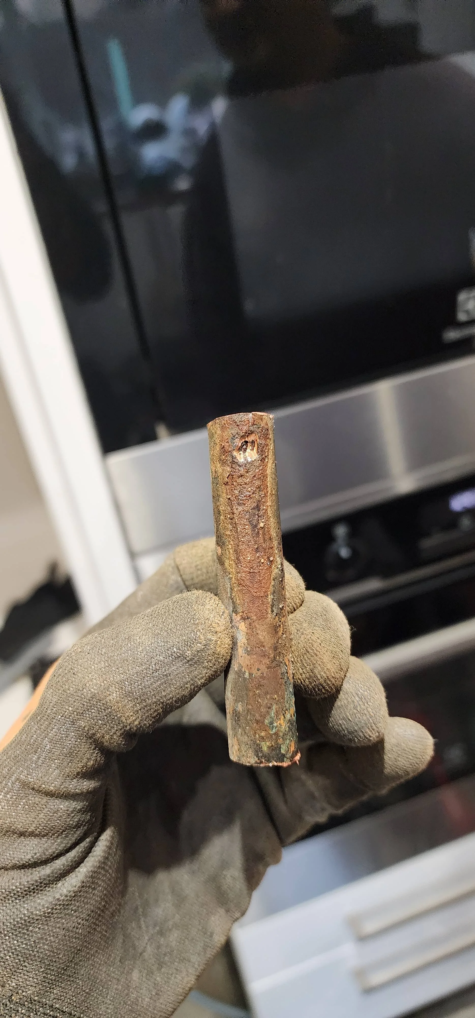 Close-up failed pipe section from Reading central heating leak investigation