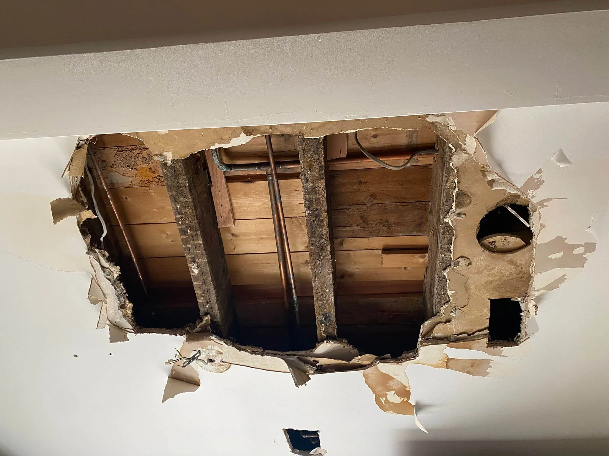 Ceiling access opened during water leak detection in Reading