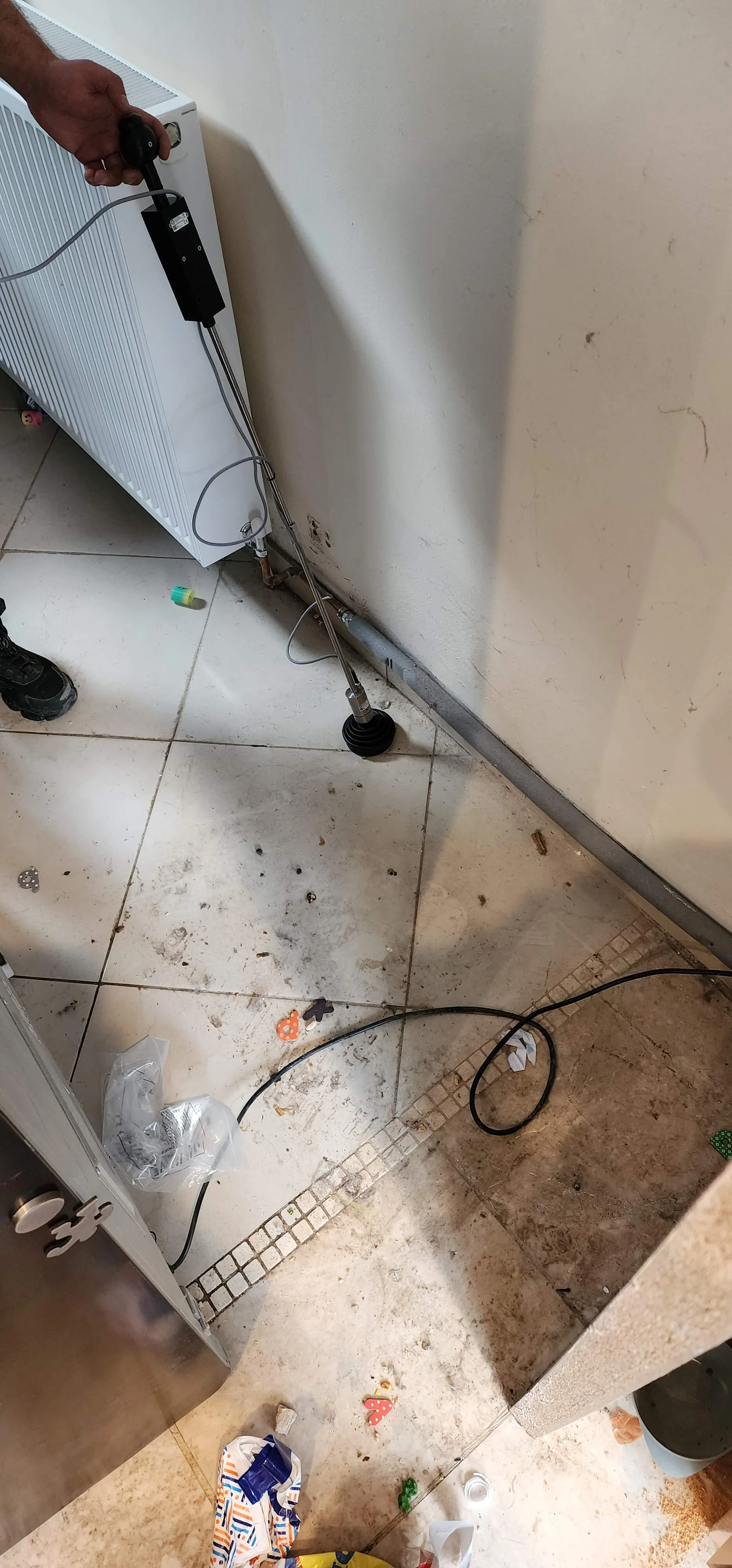 Mains water leak investigation equipment beside internal pipework in Sutton