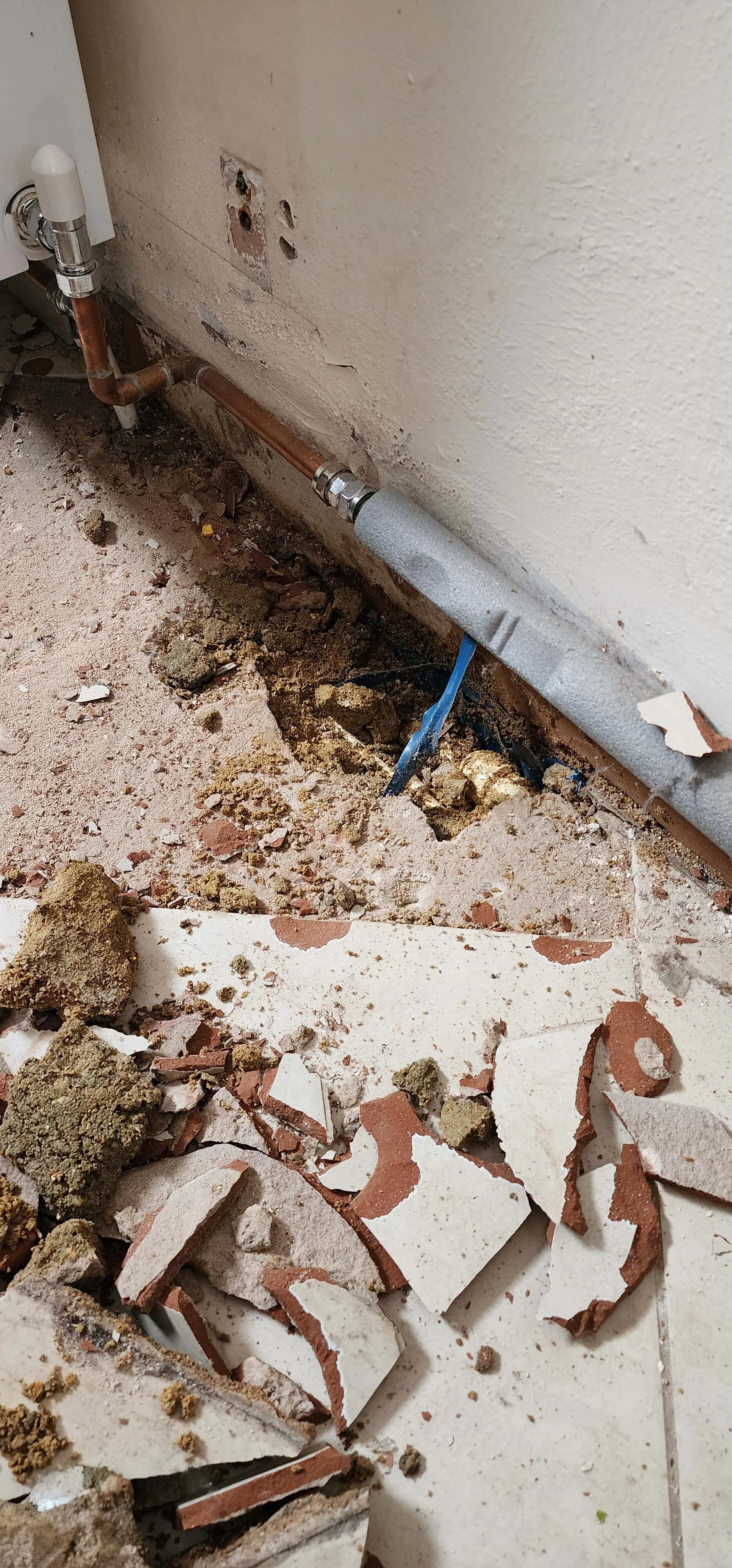 Floor area opened during mains water leak detection in Sutton
