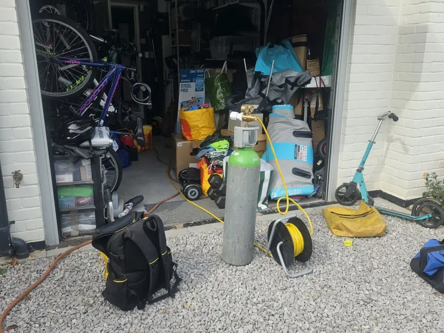Tracer gas cylinder and hose reel positioned outside the property during the investigation