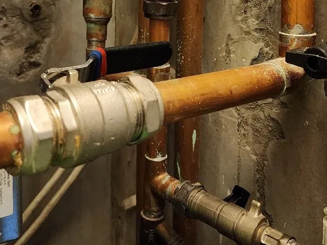 Concealed heating pipework inspected during leak investigation