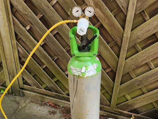 Tracer gas cylinder used during supply pipe leak investigation